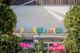 Built-in outdoor seating with colourful cushions including Crémaillère in Prato, surrounded by greenery. Design by The Rusland Movement, photography by India Polkinghorne.
